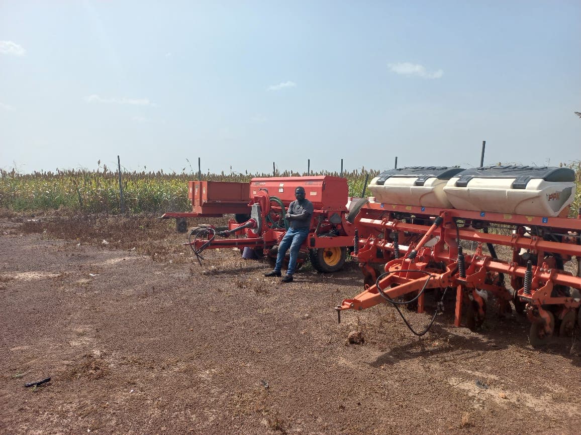 A technician with the mechanised planter in the field