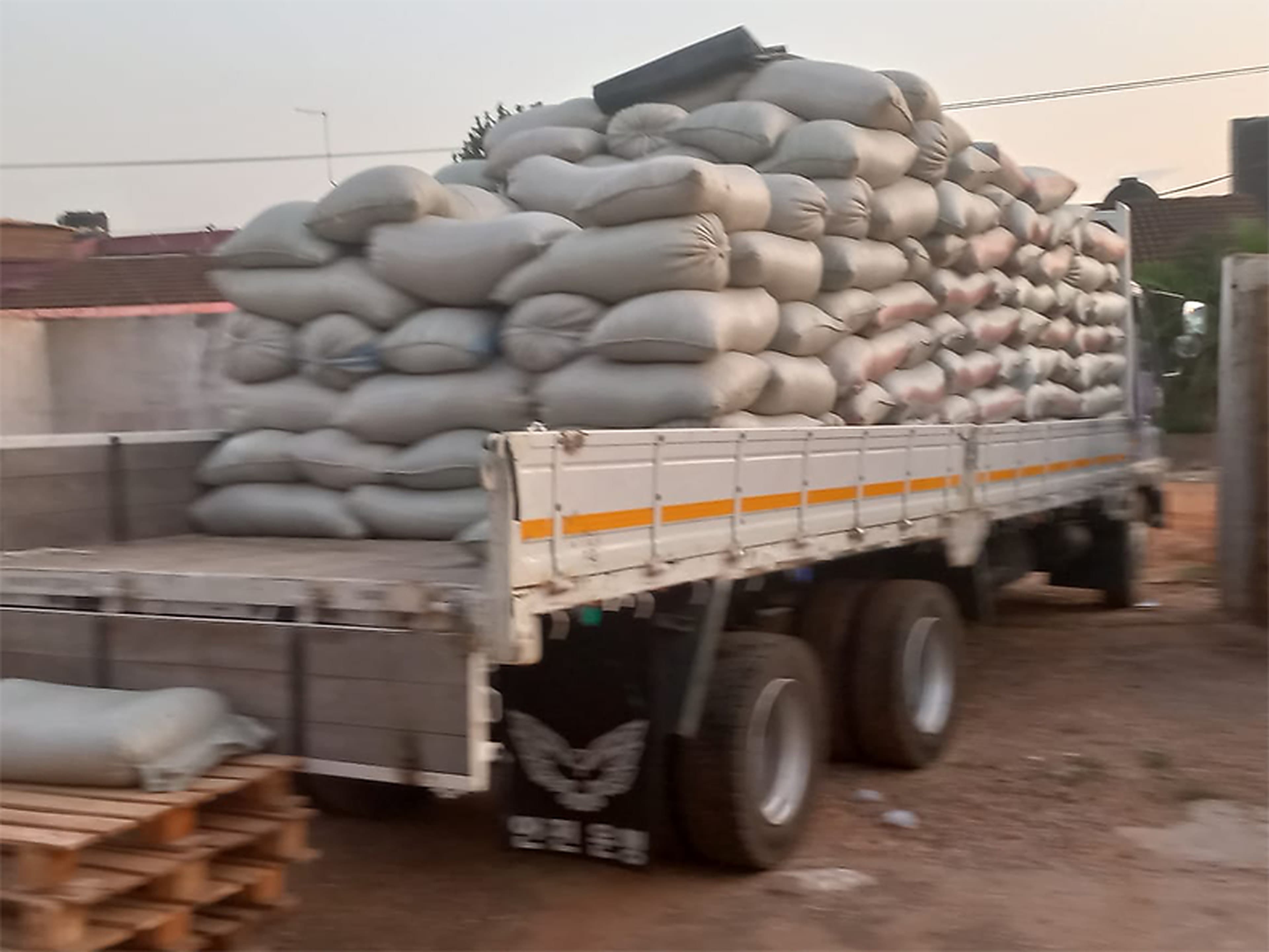 Truck being loaded with bagged grain